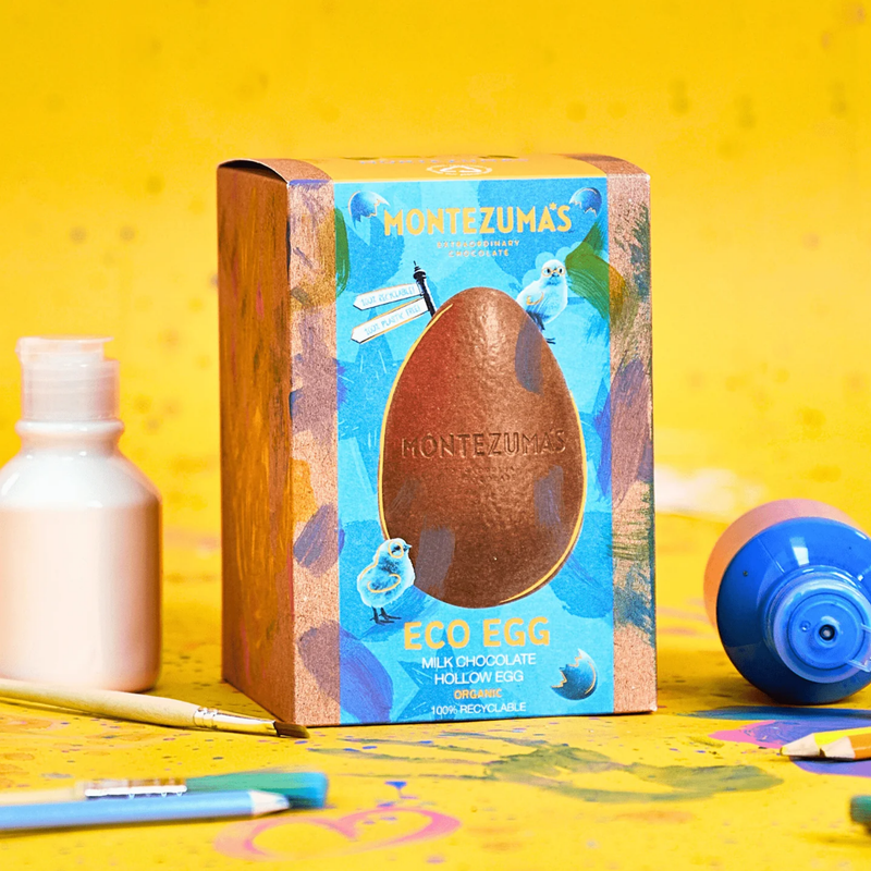 Montezuma's Eco Egg packaging on a yellow background with stationery items.